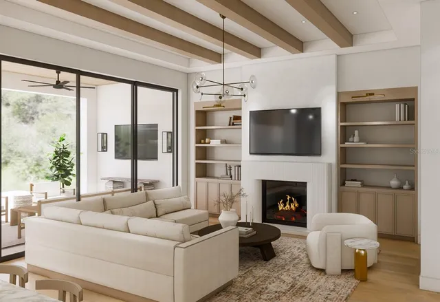 a living room with furniture a fireplace and a large window