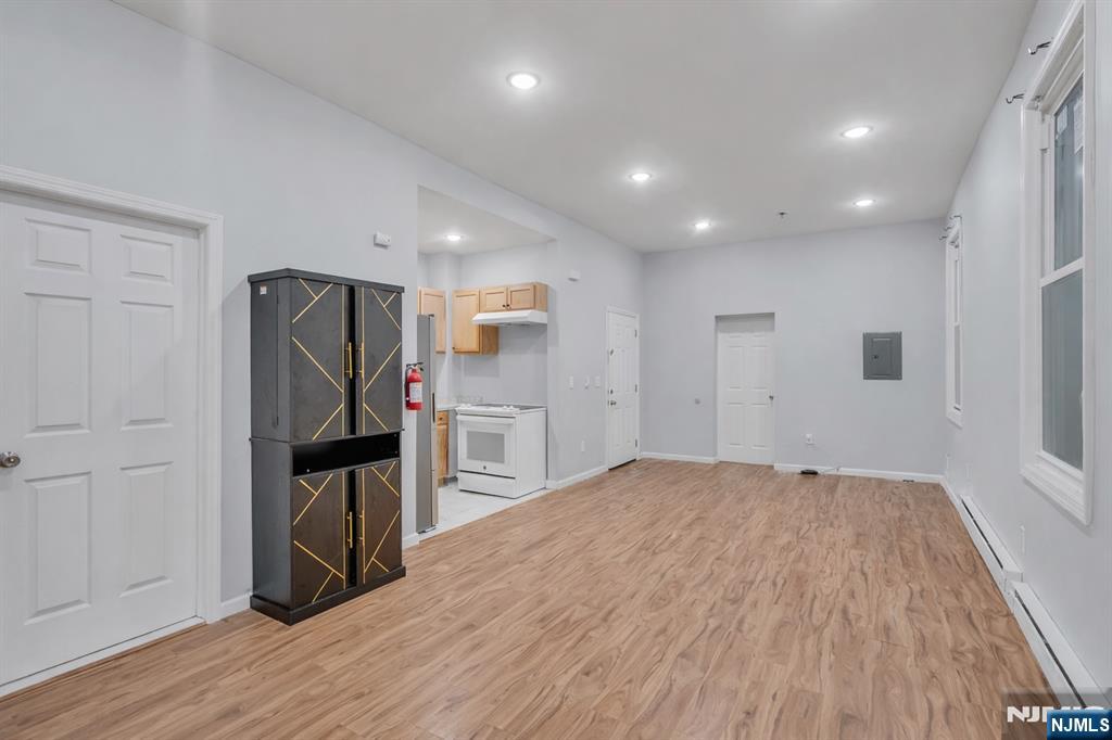 90 Park Avenue Paterson, NJ 07501 - Photo 11 of 42 a view of kitchen with refrigerator microwave and wooden floor