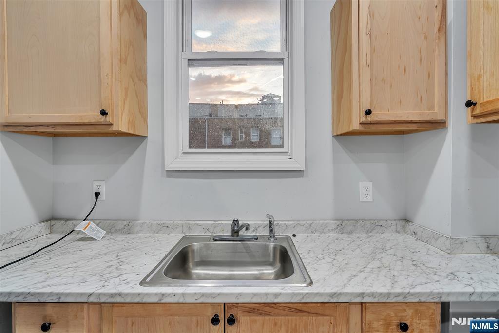 90 Park Avenue Paterson, NJ 07501 - Photo 15 of 42 a kitchen sink with granite countertop a sink and cabinets
