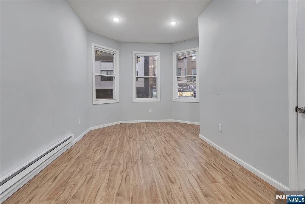 90 Park Avenue Paterson, NJ 07501 - Photo 16 of 42 wooden floor in an empty room with a window
