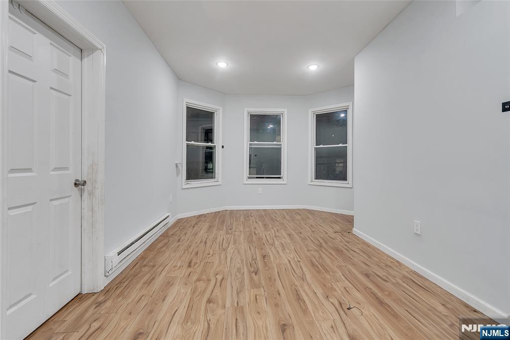 90 Park Avenue Paterson, NJ 07501 - Photo 17 of 42 a view of empty room with wooden floor and fan