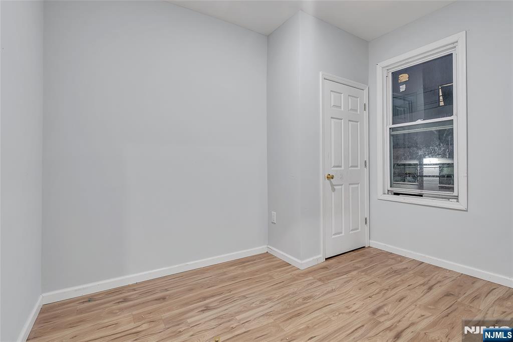 90 Park Avenue Paterson, NJ 07501 - Photo 20 of 42 a view of an empty room with wooden floor and a window