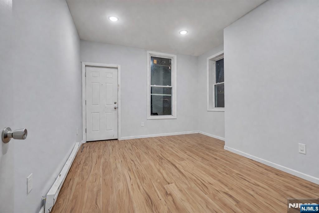 90 Park Avenue Paterson, NJ 07501 - Photo 21 of 42 wooden floor in an empty room with a window