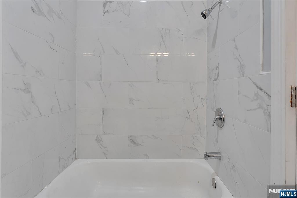 90 Park Avenue Paterson, NJ 07501 - Photo 22 of 42 a bathroom with a bathtub