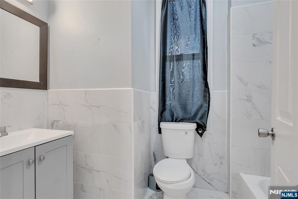 90 Park Avenue Paterson, NJ 07501 - Photo 24 of 42 a bathroom with a toilet sink and shower