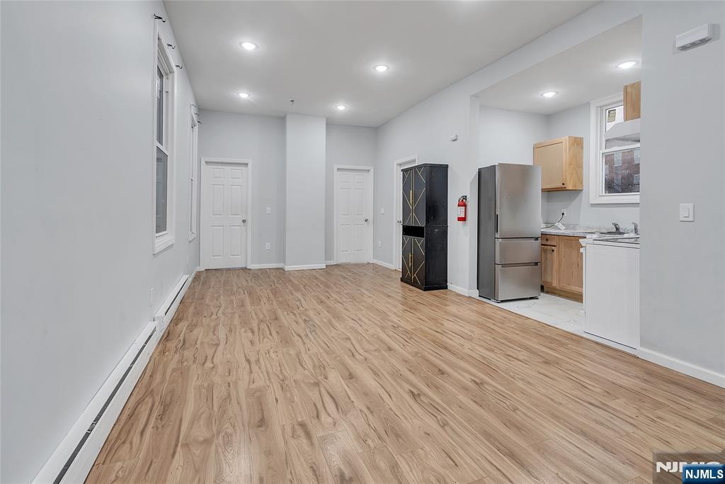 90 Park Avenue Paterson, NJ 07501 - Photo 6 of 42 a view of kitchen with refrigerator stove and wooden floor