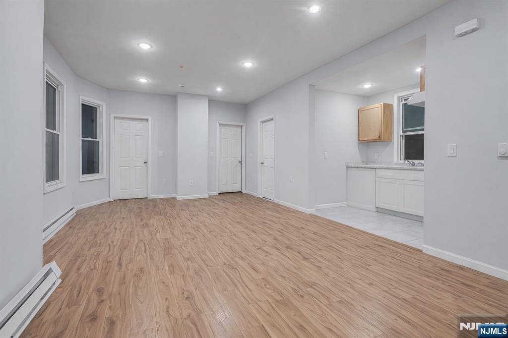 90 Park Avenue Paterson, NJ 07501 - Photo 10 of 42 a view of empty room with wooden floor and fan