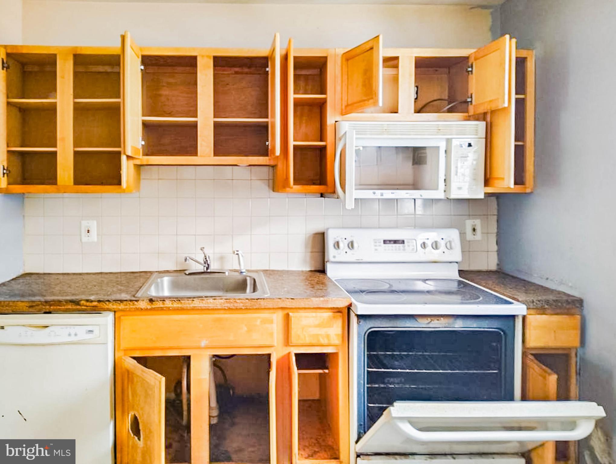 619 Brill Street Philadelphia, PA 19120 - Photo 6 of 18 a view of a kitchen with stainless steel appliances granite countertop a stove and a sink