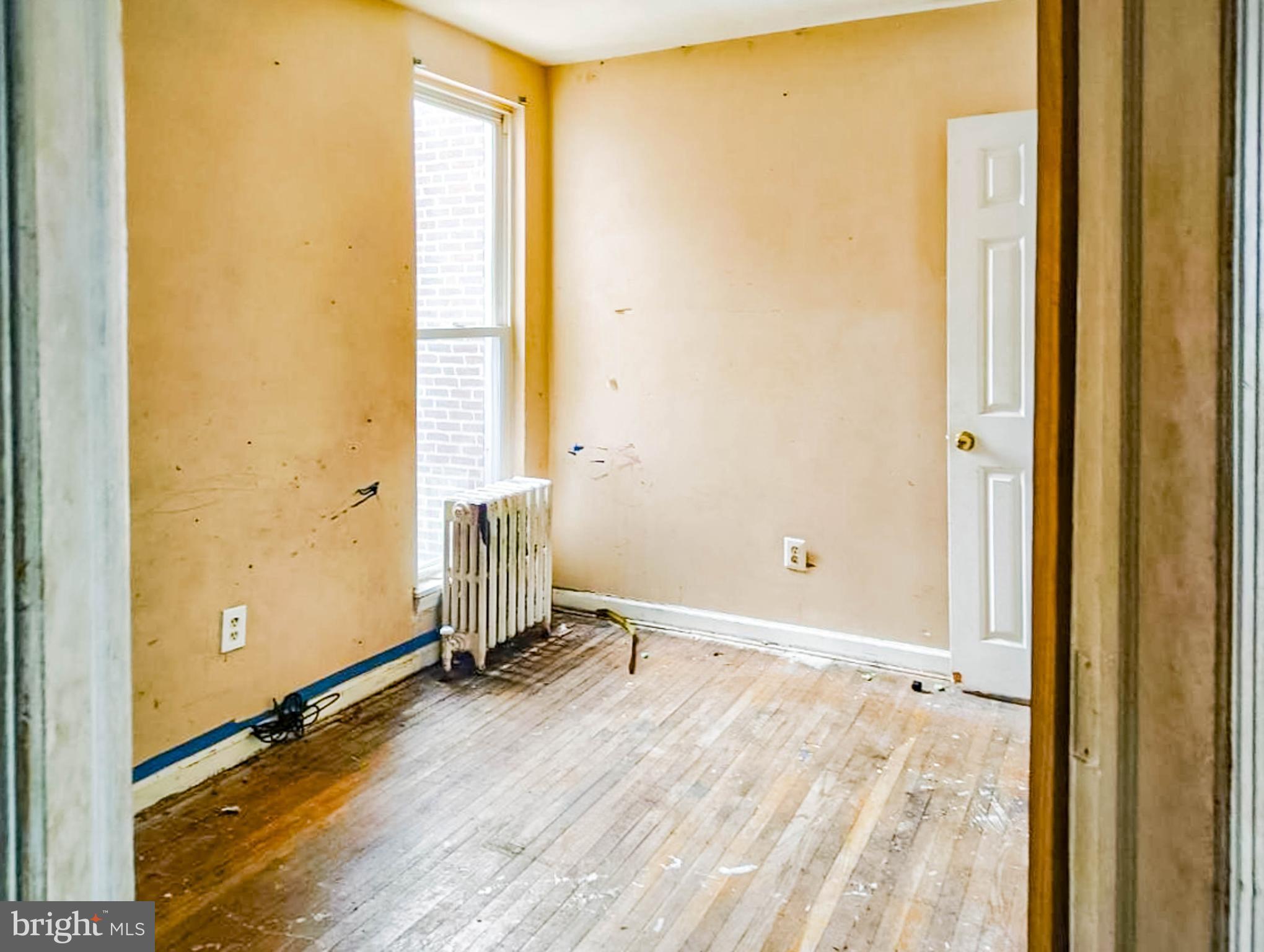 619 Brill Street Philadelphia, PA 19120 - Photo 10 of 18 a view of a room with wooden floor and windows