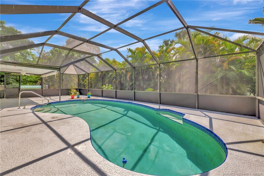 6806 Southwest Chase Court Stuart, FL 34997 - Photo 23 of 37 Cool Off in the Enclosed Saltwater Pool!