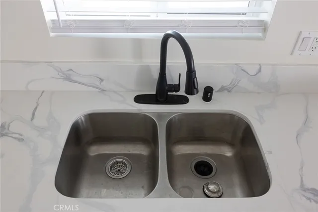 a bathroom with a washing machine and a sink