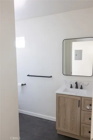 a white toilet sitting in a bathroom next to a sink