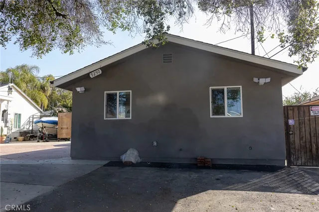 a house that has a tree in front of it