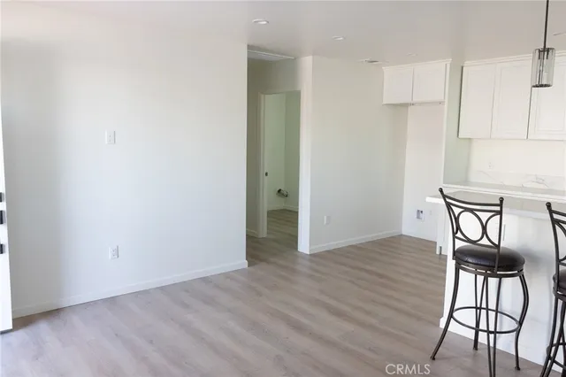 a view of an empty room and wooden floor