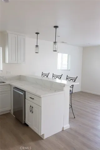 a view of a kitchen with sink and dishwasher