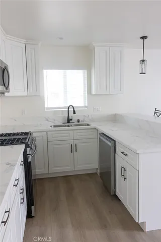 a kitchen with a sink stove and cabinets