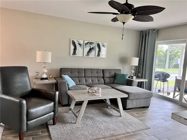 a living room with furniture and a large window