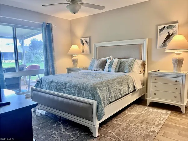 a bedroom with a bed and a night stand