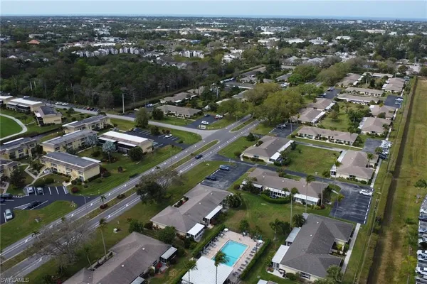 an aerial view of residential houses with outdoor space