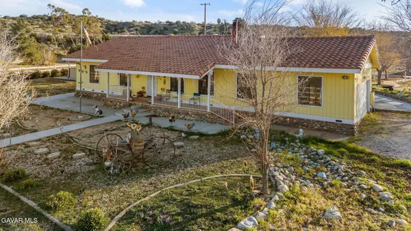 a aerial view of a house with large trees