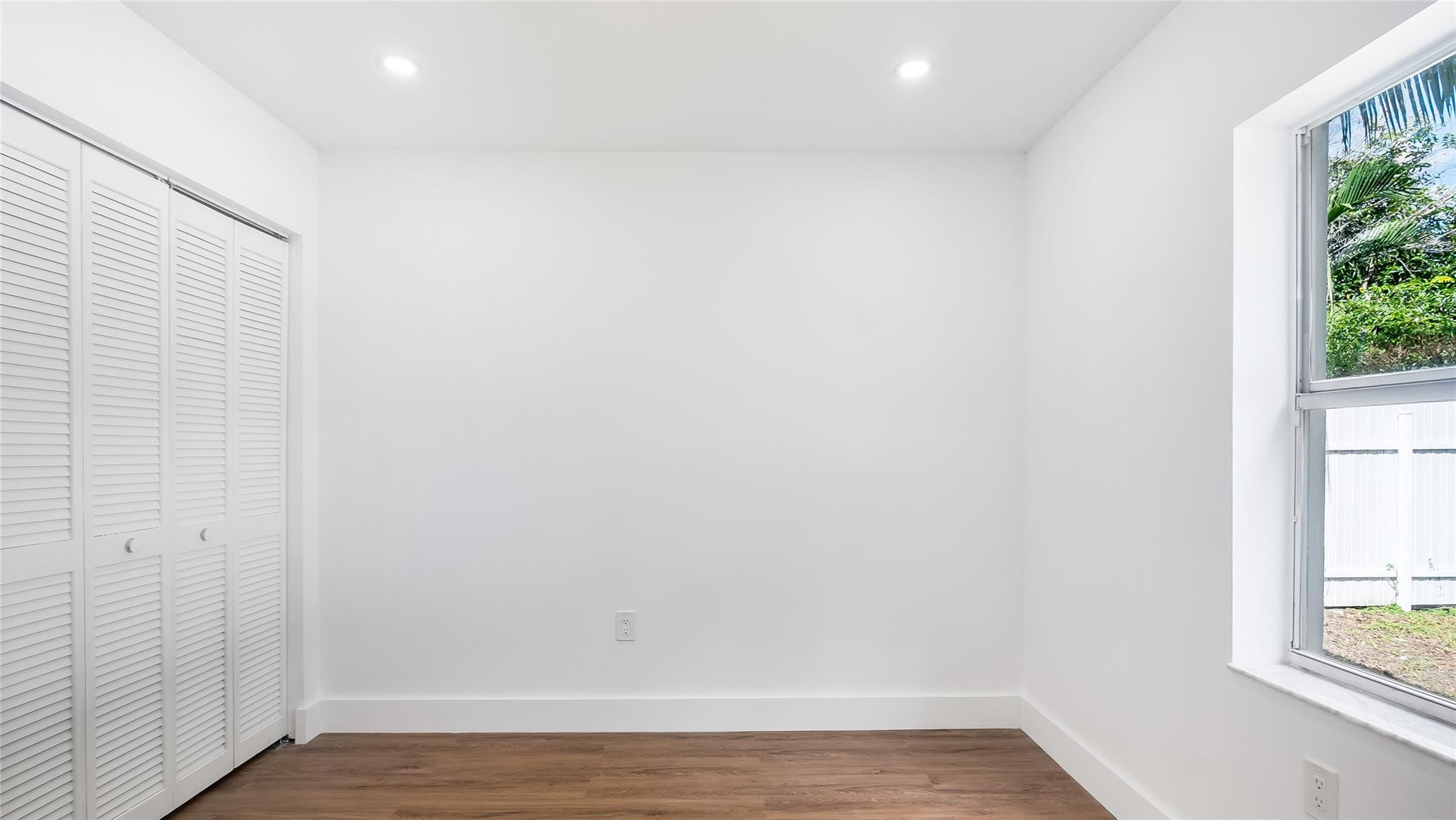 1811 Southwest 124th Way Miramar, FL 33027 - Photo 14 of 28 a view of an empty room with wooden floor and a window