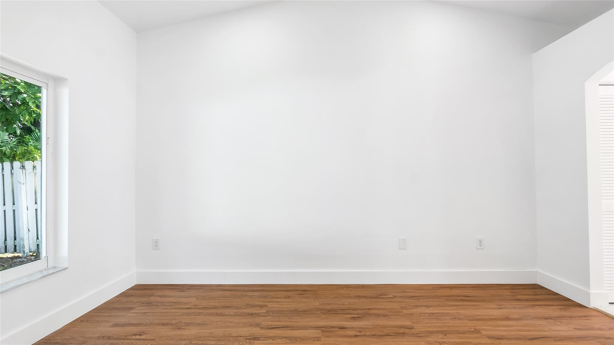1811 Southwest 124th Way Miramar, FL 33027 - Photo 22 of 28 a view of an empty room with wooden floor and a window