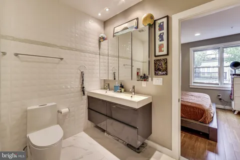 a bathroom with a sink a toilet and a shower