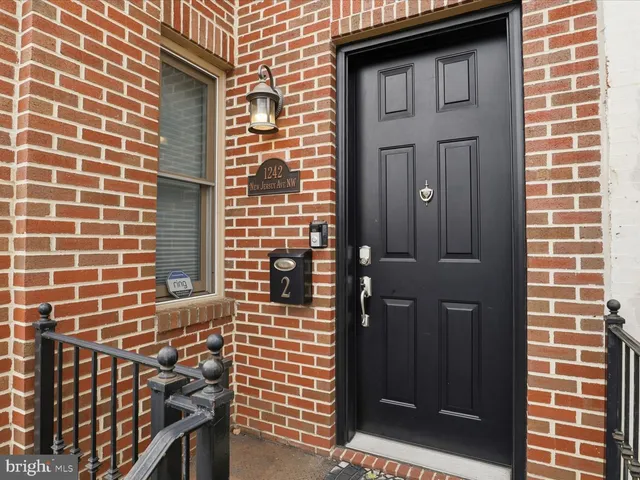 a living room with furniture a flat screen tv and a large window
