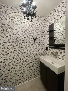 a bathroom with a sink toilet and mirror