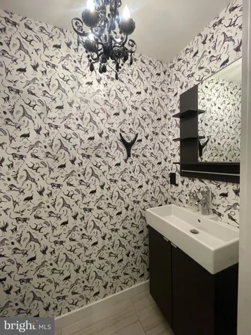 a bathroom with a sink toilet and mirror