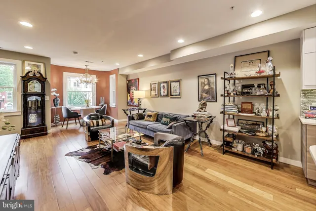 a dining room with furniture a chandelier and wooden floor