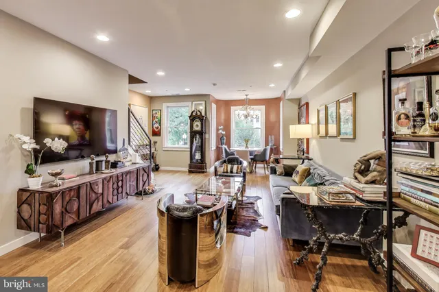 a kitchen with stainless steel appliances granite countertop a refrigerator a stove top oven a sink dishwasher and white countertops with wooden floor