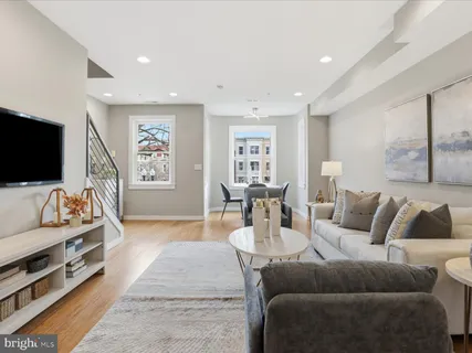 a kitchen with stainless steel appliances granite countertop a refrigerator a stove and a wooden floors