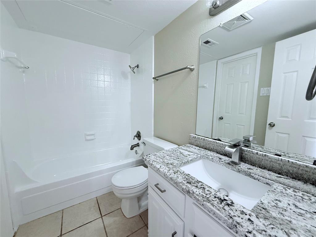 777 Custer Road, Unit 23 Richardson, TX 75080 - Photo 15 of 28 Full bathroom with shower / washtub combination, light tile patterned flooring, and vanity