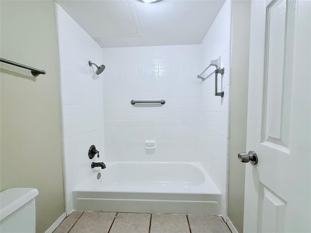 777 Custer Road, Unit 23 Richardson, TX 75080 - Photo 16 of 28 Bathroom with shower / tub combination and light tile patterned floors