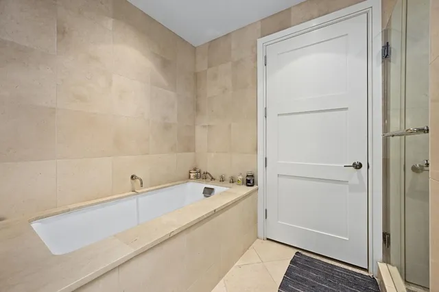 a bathroom with a tub and a shower