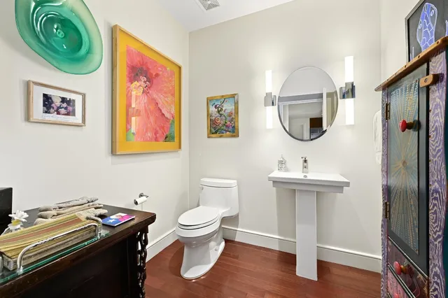 a bathroom with a toilet a sink and a mirror