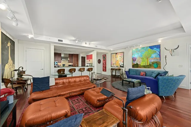 a living room with furniture kitchen and a table