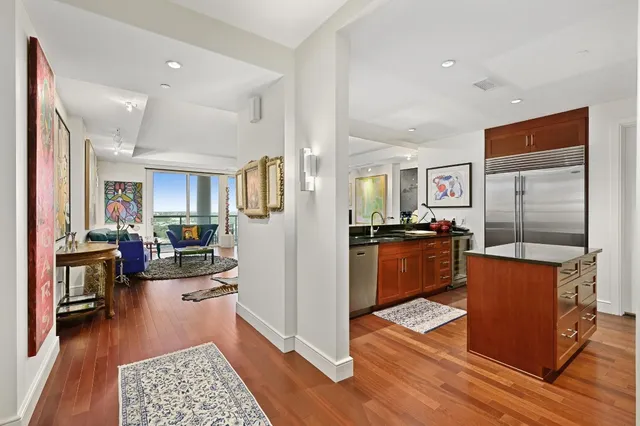 a view of a living room kitchen and a wooden floor