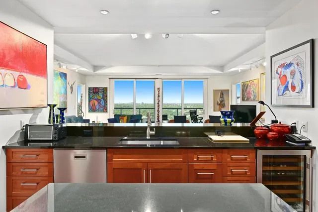 a kitchen with stainless steel appliances granite countertop a stove and cabinets