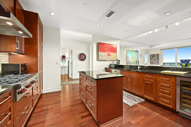 a kitchen with stainless steel appliances granite countertop a stove a sink dishwasher and a refrigerator