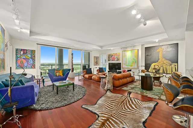a living room with furniture kitchen and a table