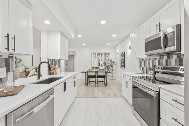 a kitchen with stainless steel appliances granite countertop a stove and a sink