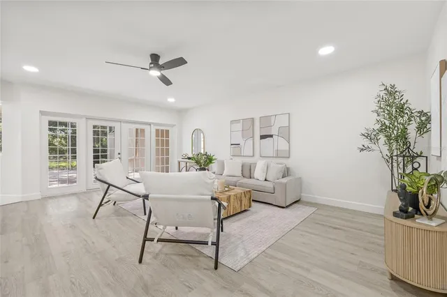 a living room with furniture and a potted plant