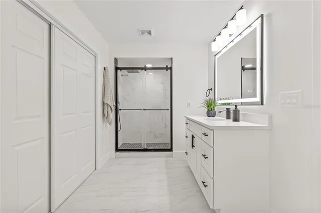 a bathroom with a double vanity sink and mirror