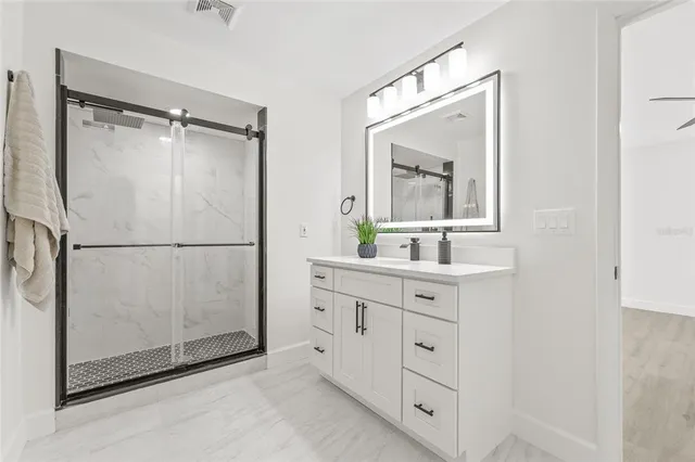 a bathroom with a double vanity sink mirror and cabinets