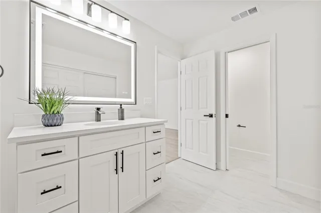 a bathroom with a double vanity sink and a mirror