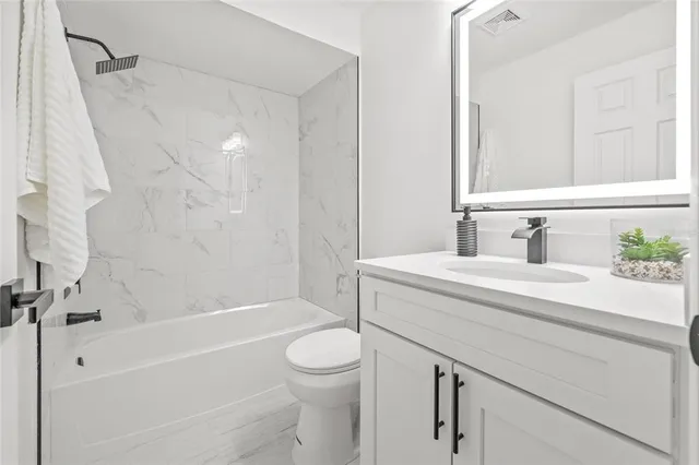 a bathroom with a sink a toilet and a bathtub