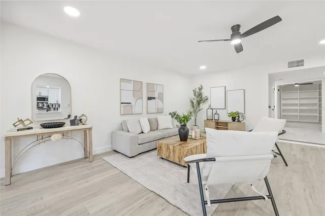 a living room with furniture and a wooden floor
