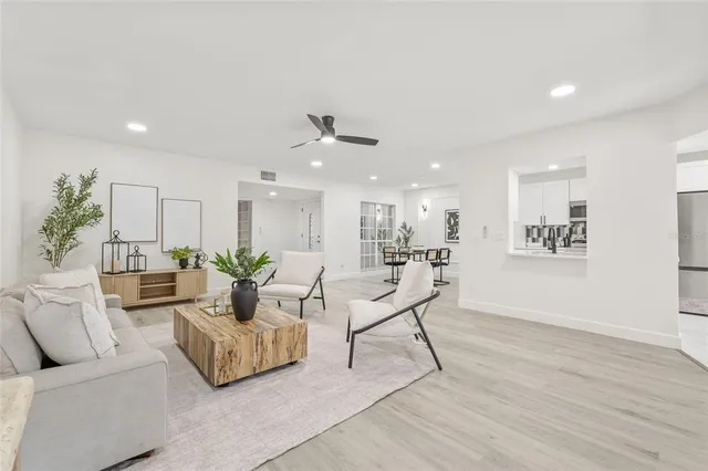 a living room with furniture and a wooden floor